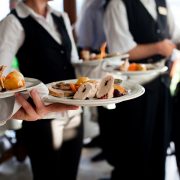 Waiters,Carrying,Plates,With,Meat,Dish,At,A,Wedding