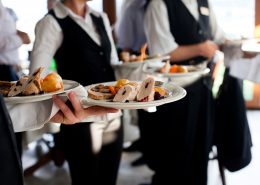 Waiters,Carrying,Plates,With,Meat,Dish,At,A,Wedding